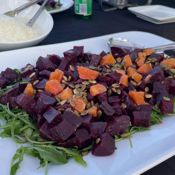 Beet salad with greens on white plate