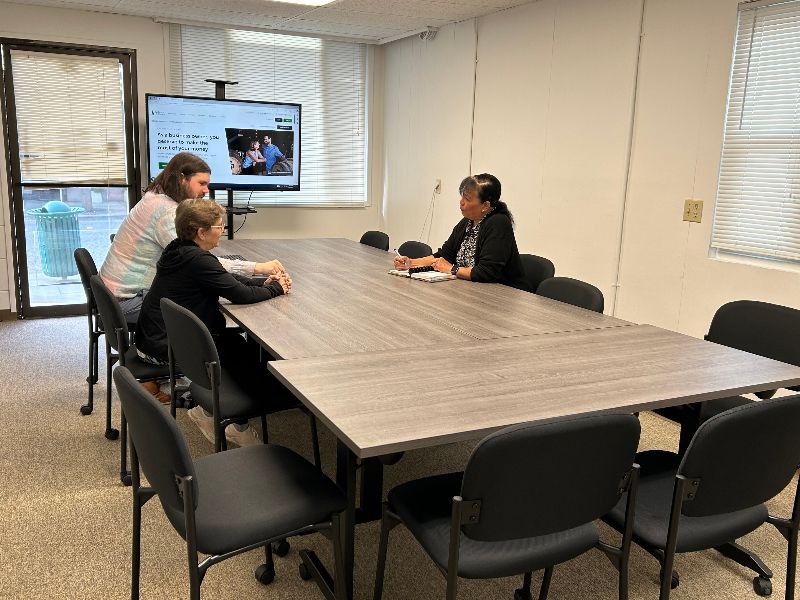 People sitting around table talking in an office 