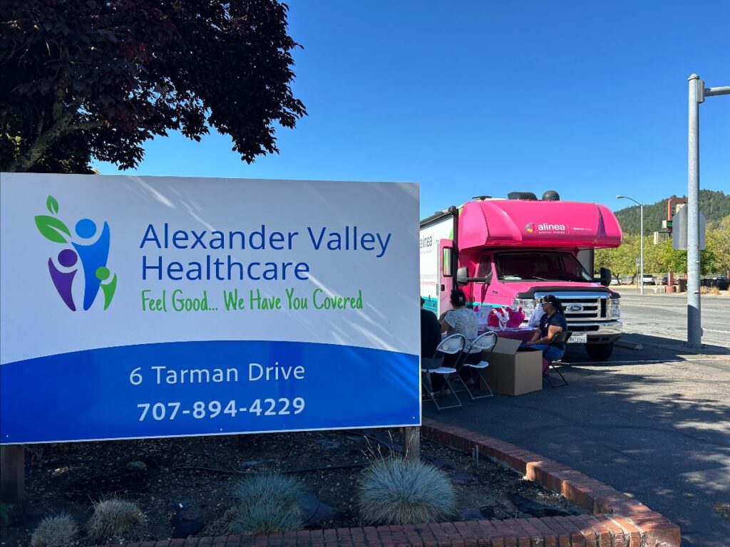 Alexander Valley Healthcare sign with a slight view of pink motorhome