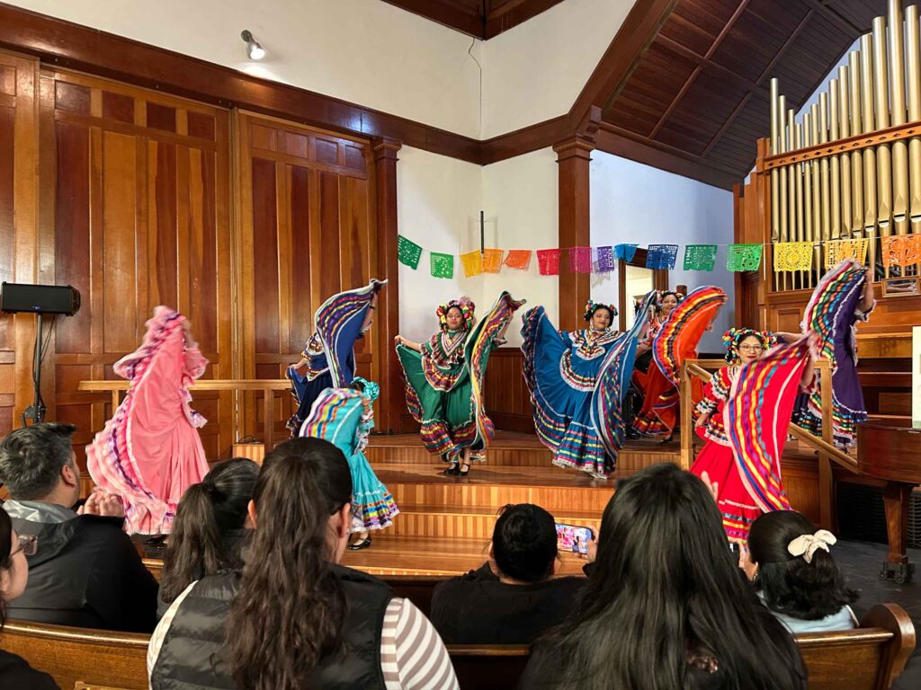 flamenco dancers in colorful dresses on stage